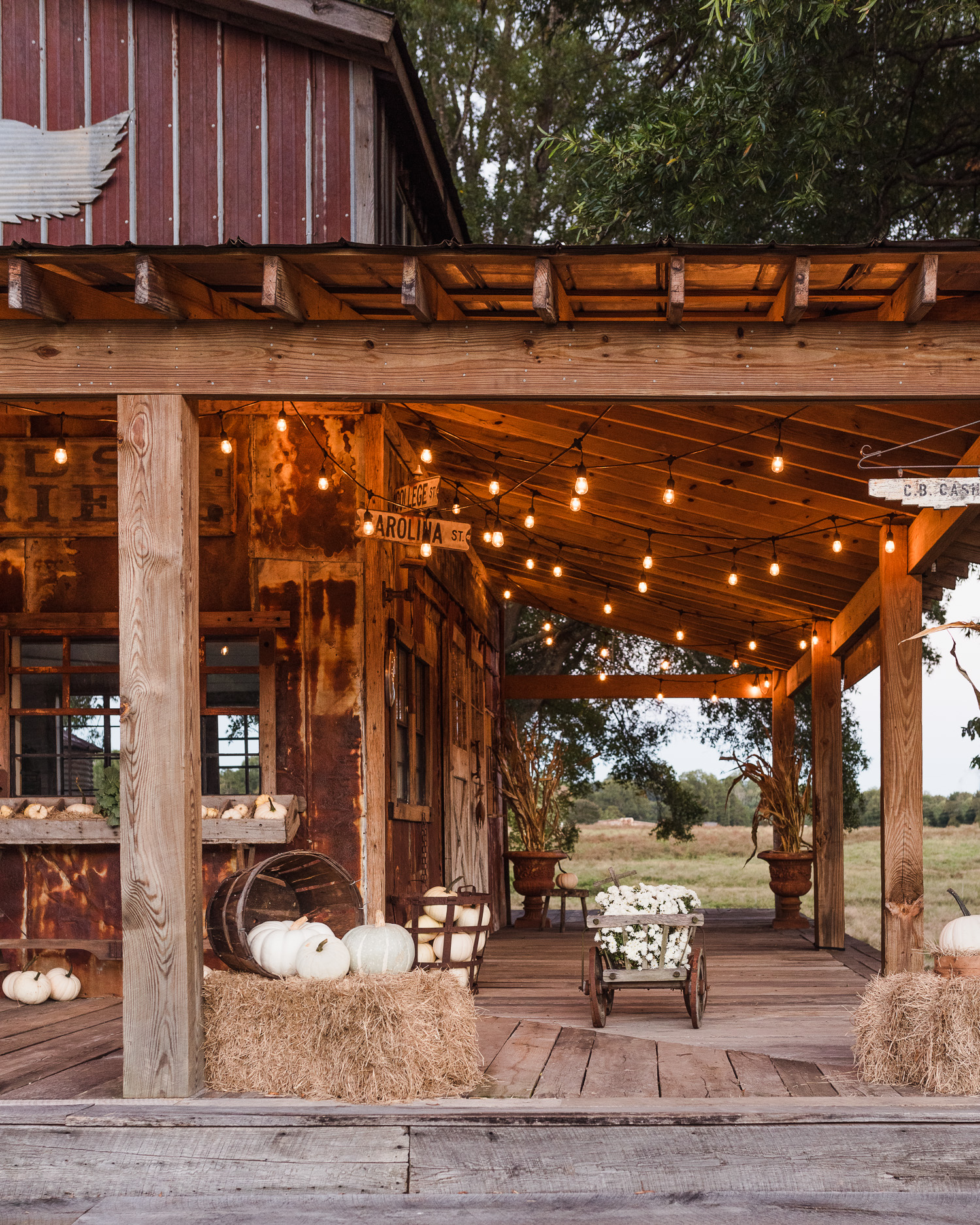 Rustic Fall Porch Decorated with vintage, pumpkins & mums