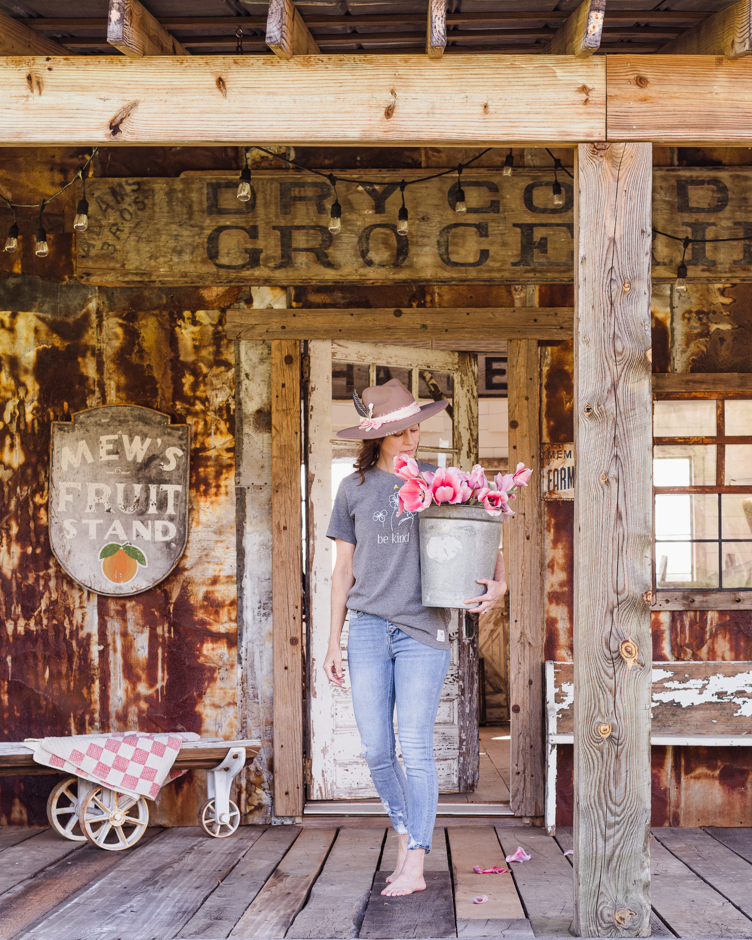Self Portrait of me with a vintage sap bucket filled with tulips. Barn Porch
