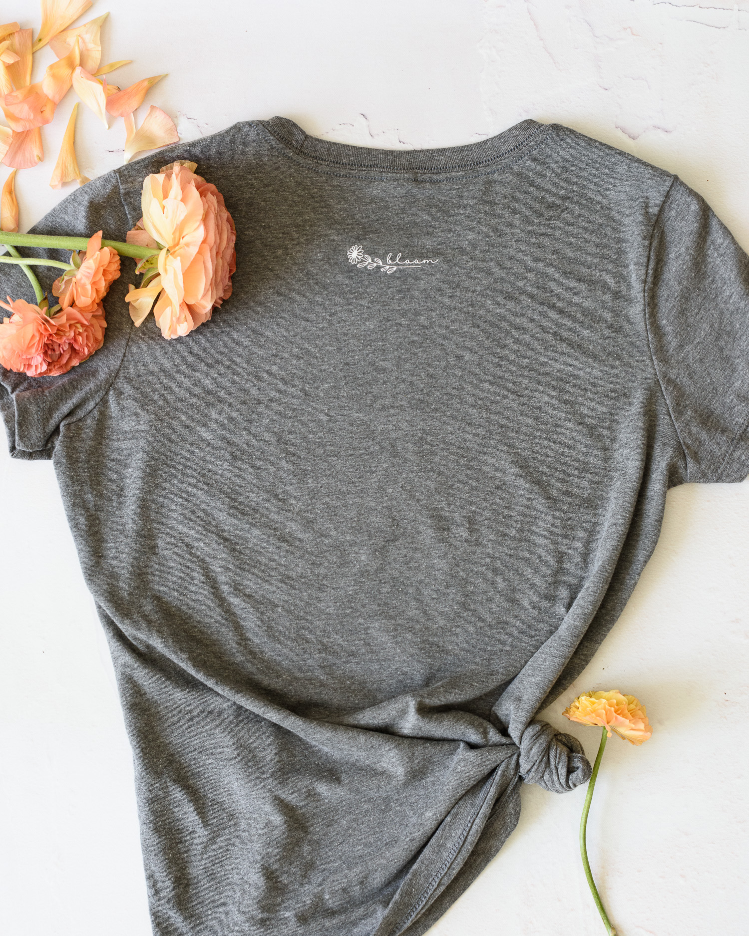 Flower Love T Shirt | Back of the shirt and the words bloom with a small flower