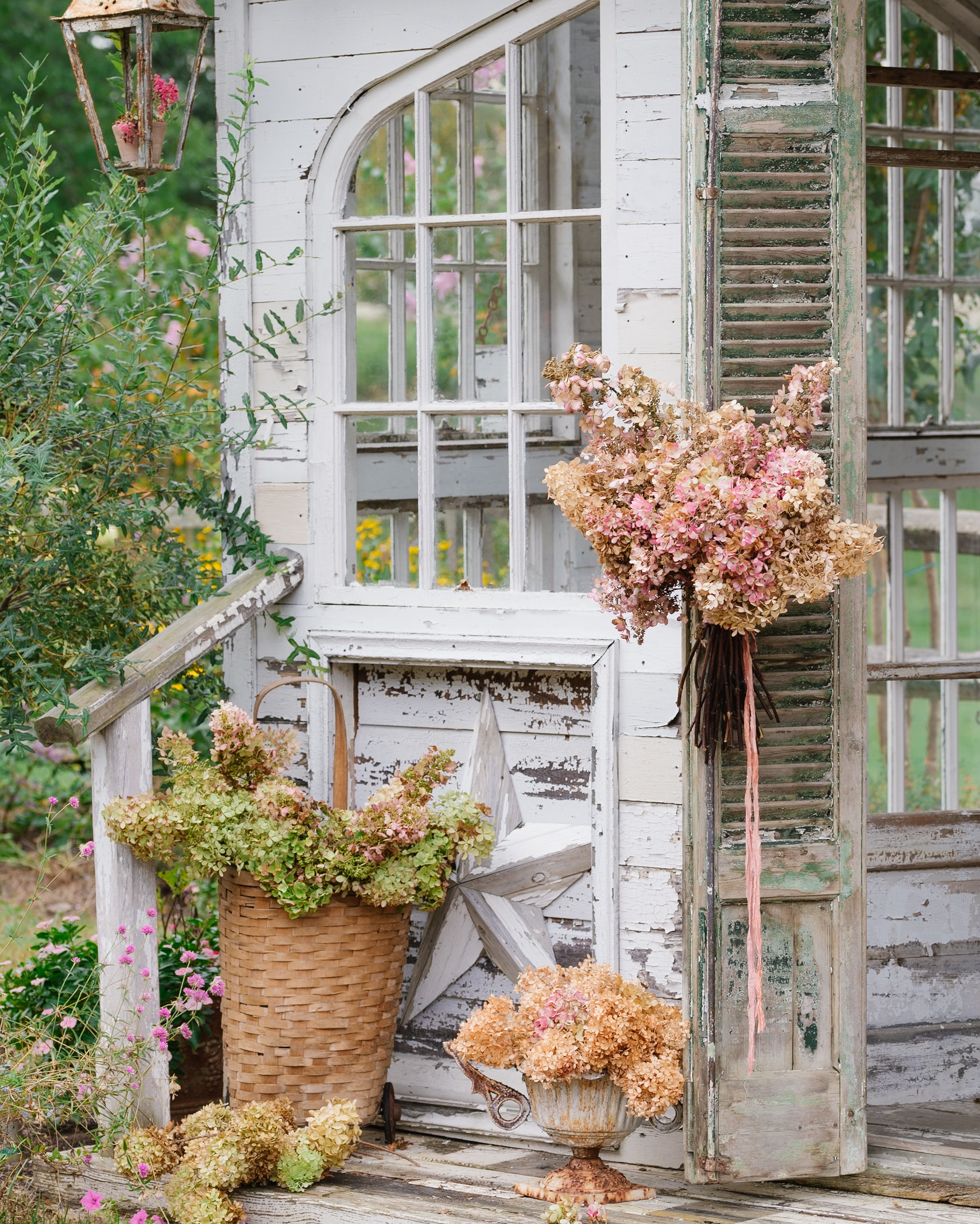 Flower House with a porch of hydrangeas and vintage baskets