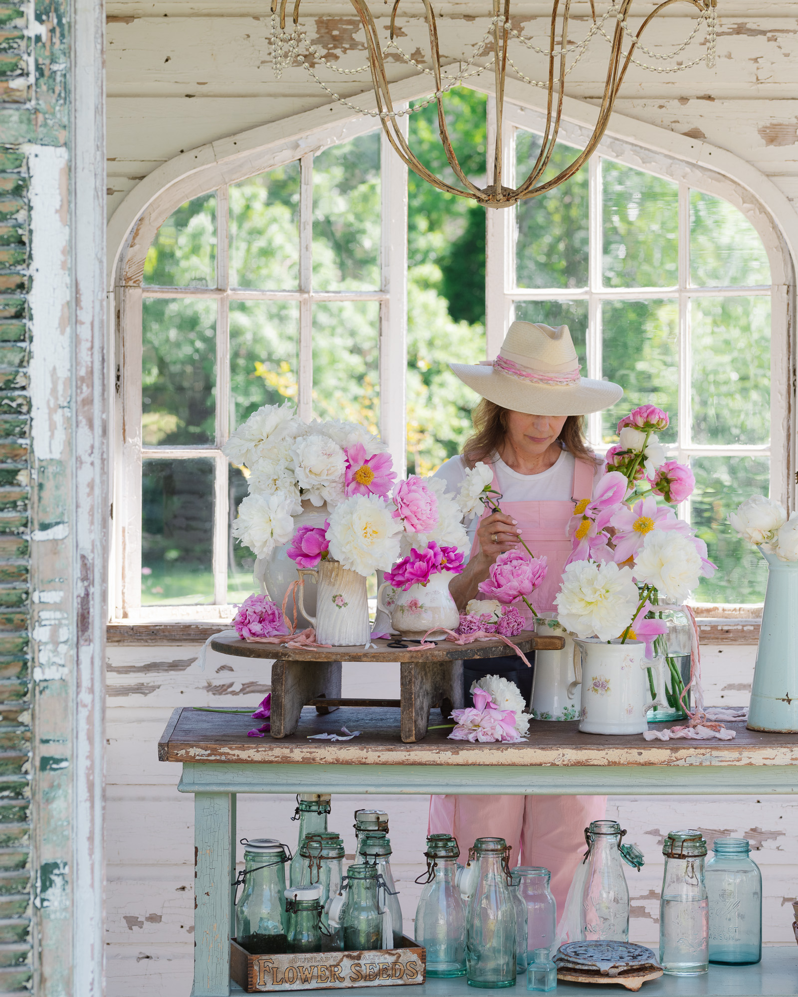 Flower Gardener in the flower house with peonies